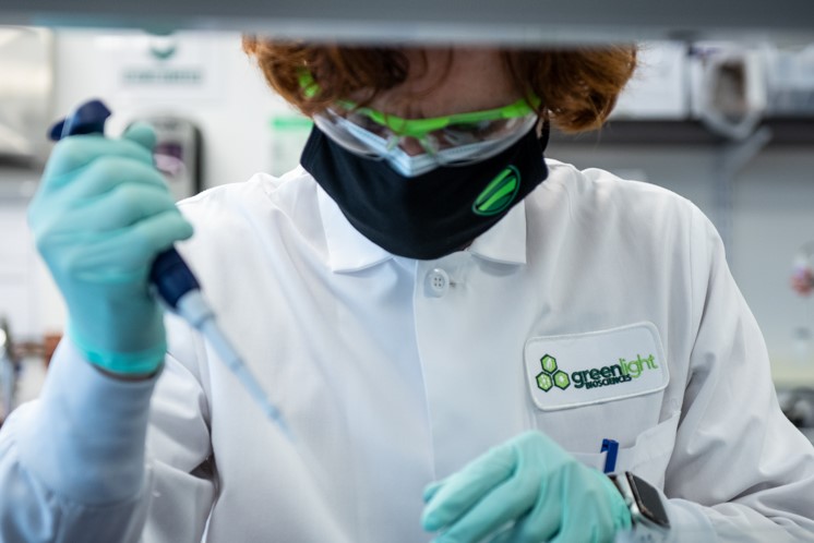 a GreenLight scientists uses a pipette in a lab